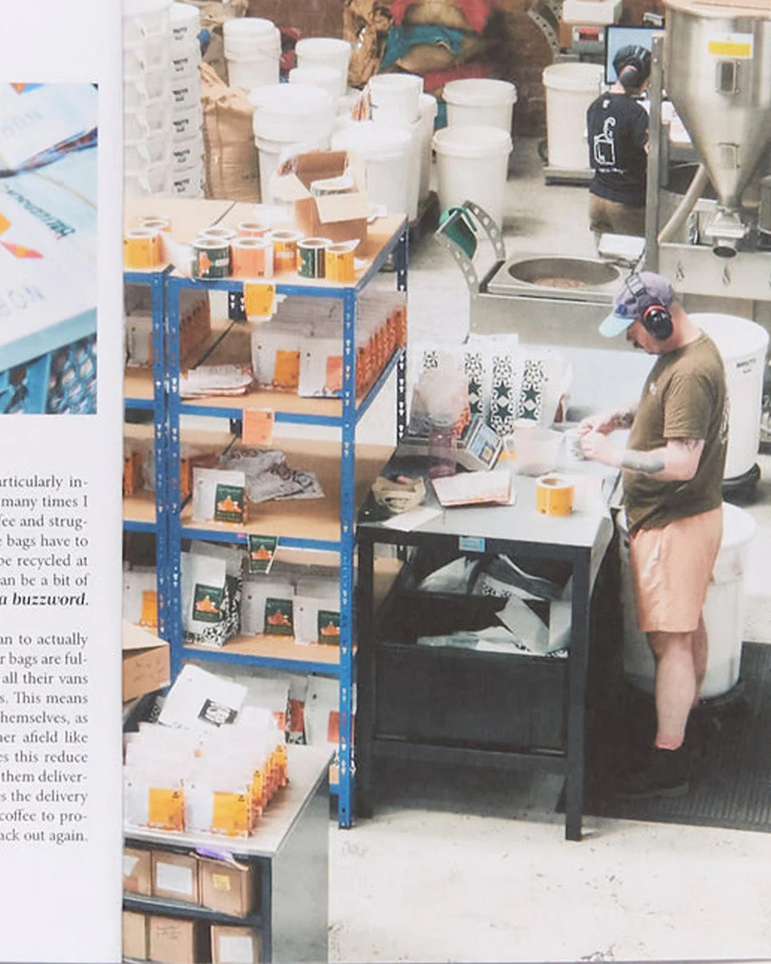 Person working in a warehouse or storage area with shelves and equipment.