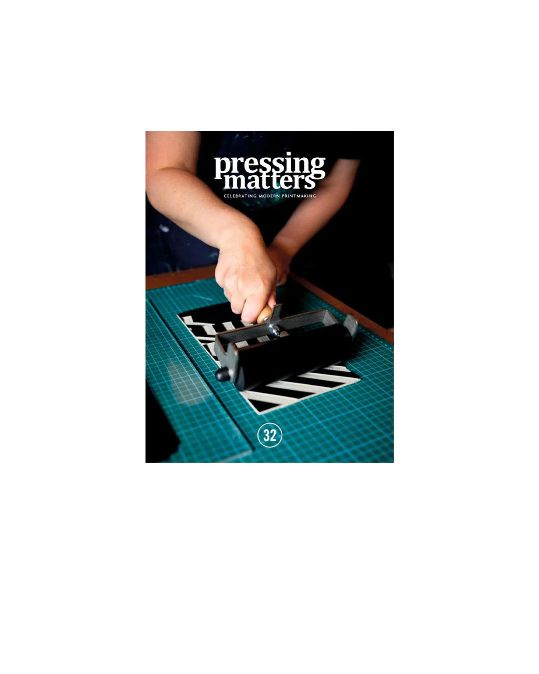 Magazine cover titled 'pressing matters' with a person making a print on a table.