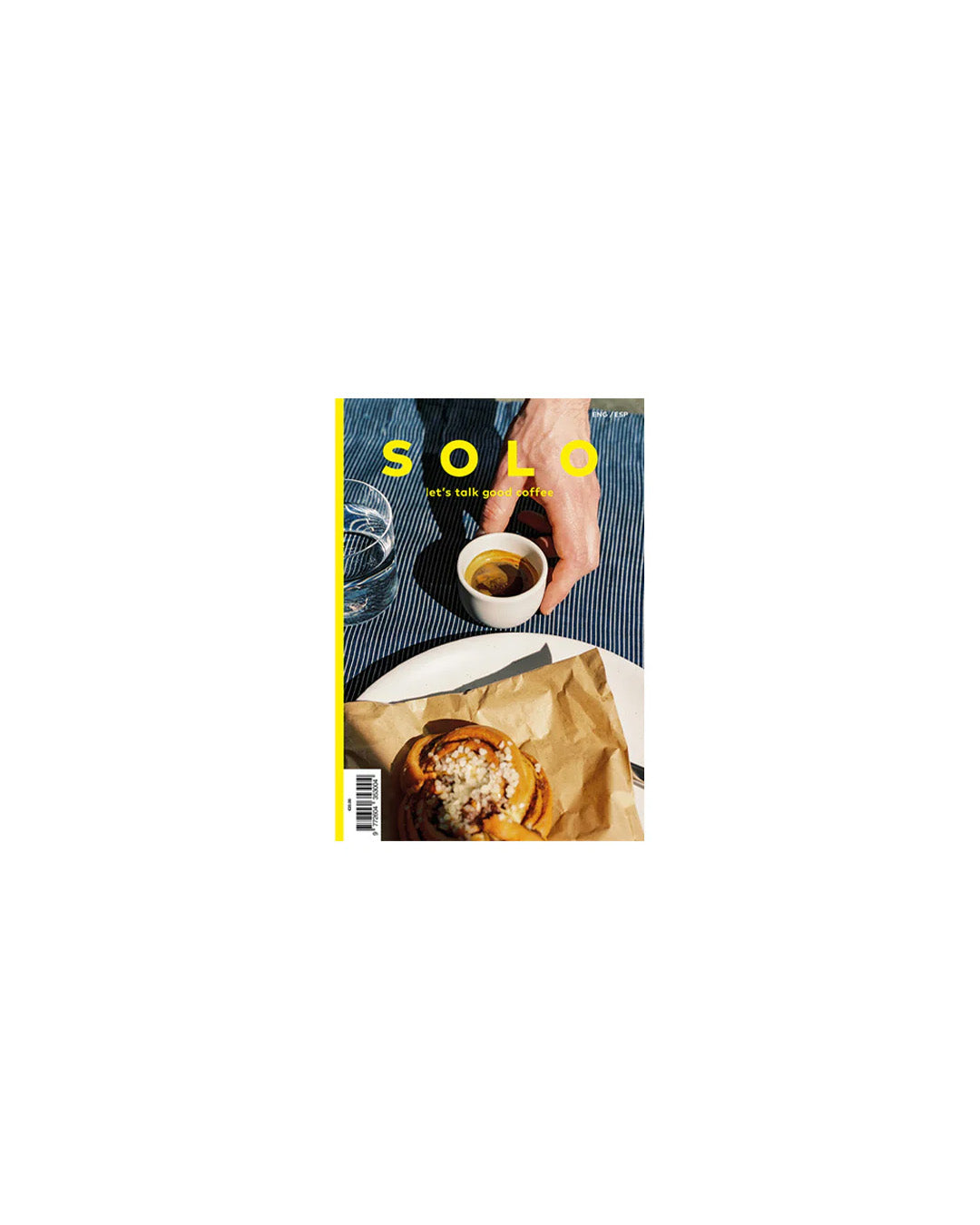 Magazine cover with a hand holding a coffee cup and a plate of food on a white background